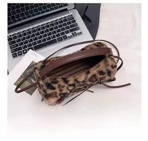 Internal view of leopard faux fur bag showing spacious dark striped lining and zip closure