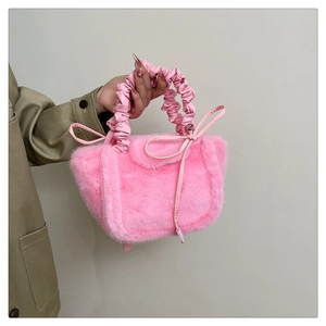 Close-up of pink plush handbag featuring soft faux fur and elegant ruched handle detail