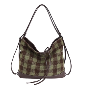Retro contrast color plaid tote bag with brown leather straps and bow on white background
