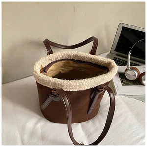 Top view of brown suede bucket bag with white fleece trim and spacious interior detail