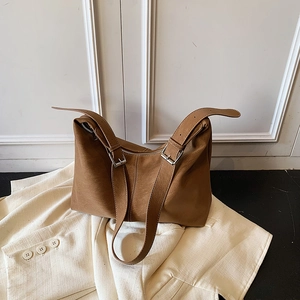 Brown faux leather tote bag with adjustable shoulder straps and silver buckles