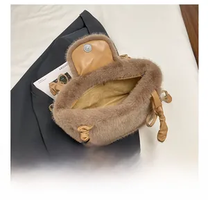 Detail view of plush brown faux fur bag showing soft texture and ruched handle