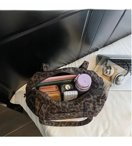Spacious interior of leopard print canvas bag showing tablet and daily essentials