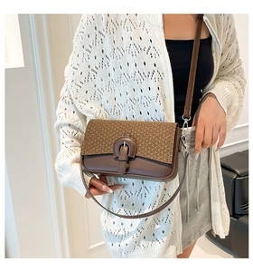 Détail du sac à bandoulière marron vintage avec rabat tissé et boucle décorative en métal