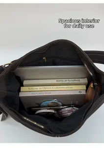 Top view of large vintage brown shoulder bag showing spacious interior with books and tablet