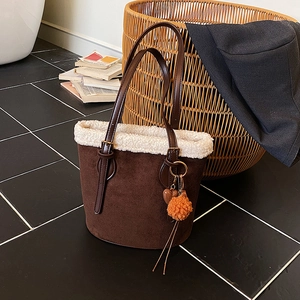Retro brown suede bucket bag with white faux shearling trim and plush ball charms