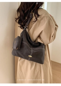 Detail of dark grey retro square bag with white contrast stitching and mini pouch