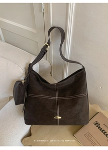 Detail of coffee suede tote bag with contrast stitching and matching mini purse