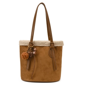 Brown suede bucket tote bag with white faux fur trim and heart shaped charm accessory