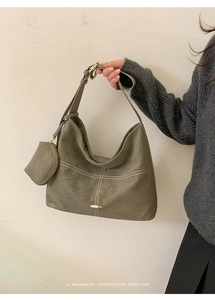 Close-up of olive gray retro handbag with white contrast stitching and mini pouch detail