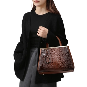 Brown crocodile embossed tote bag with gold metal beam detail and geometric charm