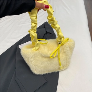 Faux fur handbag in cream yellow with pleated handle and bow detail for winter fashion