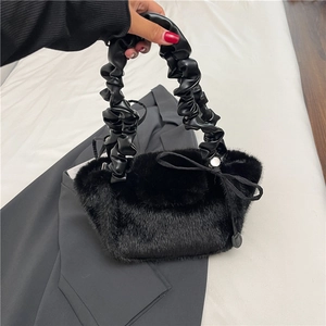 Furry black plush tote bag with ruffled leather handle and delicate bow detail decoration