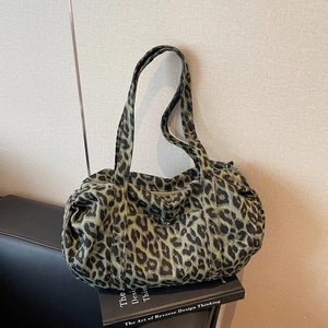 Retro leopard print canvas cylinder bag in dark green and black with long straps