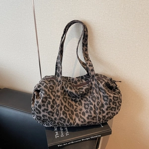 Chic leopard print canvas bowling bag with long shoulder straps and metal buckle detail