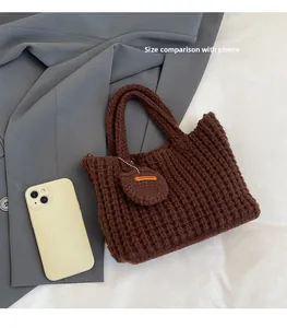 Brown crochet bag detail showing handmade texture next to a smartphone for size reference
