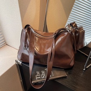 Large coffee brown leather tote bag with glossy finish and wide shoulder strap
