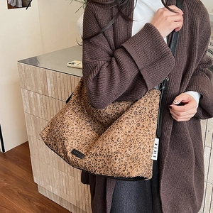 Large leopard print hobo bag with sequin fabric and long black leather shoulder straps