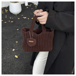 Detailed texture of dark brown hand-woven cotton shoulder bag with Hand Made tag