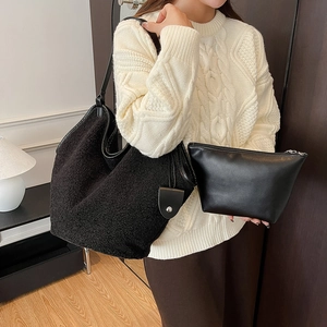 Detail of black fleece tote bag with matching leather pouch and texture contrast