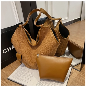 Detail of caramel wool tote bag and leather clutch with textured shearling material