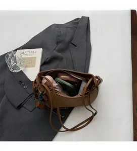 Top view of brown leather bag interior showing spacious capacity and daily items