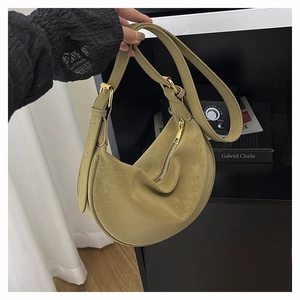 Detail of olive green crescent bag showing vintage texture and gold hardware