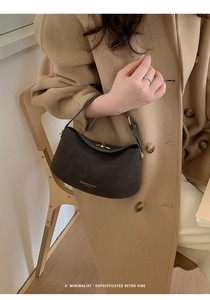 Detailed view of the dark brown matte leather texture and retro rotating metal buckle