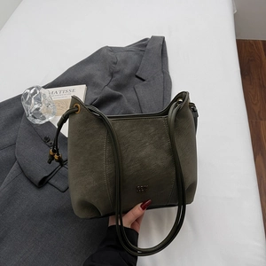 Detail of dark olive green matte leather tote bag with slim shoulder straps and drawstring