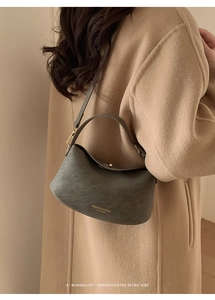 Detail of gray leather shoulder bag with printed FASHION & BAGS LEATHER logo text