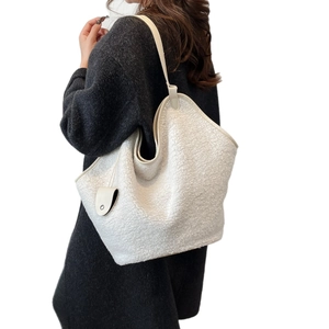 White teddy fleece tote bag with leather straps and decorative charm for women