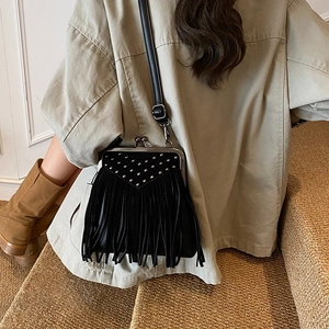 Retro black fringe crossbody bag with silver studs and adjustable strap on model
