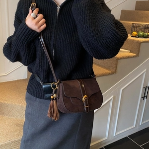 Retro dark brown suede saddle bag with metal buckle and fringe tassel detail