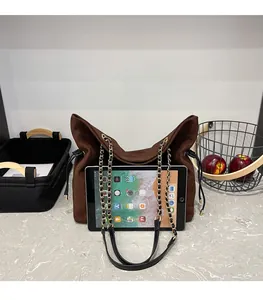 Deep brown suede tote bag with drawstring detail and iPad for size comparison