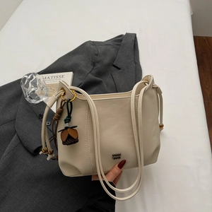Chic cream leather tote bag with a flower charm and dual straps for office style