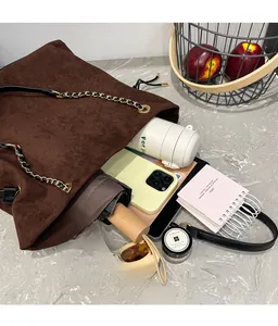Top view of large brown suede bucket bag showing spacious interior with daily essentials