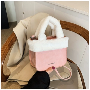 Detail of pink faux fur bucket bag with FASHION & BAGS text and soft plush handle