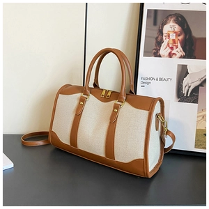 Chic beige canvas and brown leather Boston bag with vintage hardware for travel