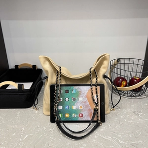 Detail showing the large capacity of the beige drawstring tote bag with a 10-inch tablet