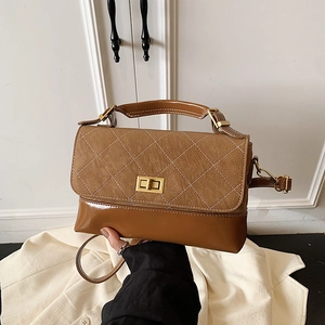 Vintage brown quilted crossbody bag with golden twist lock and elegant top handle