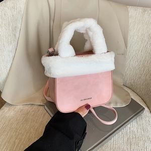 Pink faux suede bucket bag with plush white faux fur trim and detachable crossbody strap