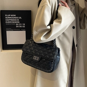 Classic black quilted shoulder bag with silver chain strap and metal swivel lock