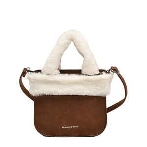 Brown faux leather bucket bag with plush white faux fur trim and adjustable strap