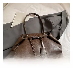 Detailed view of the vintage brown oil wax leather texture on a minimalist tote bag