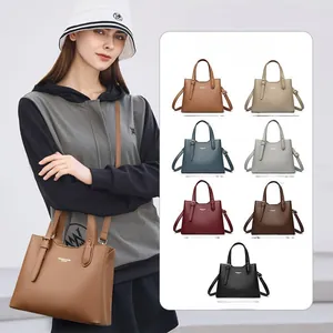 Detail view of khaki faux leather tote bag with top handle and multi-color options display