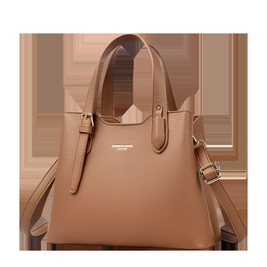 Detail of brown litchi pattern leather tote with golden hardware and fashion logo