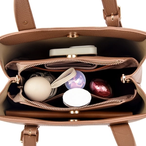 Internal layout of brown leather tote showing three main compartments and storage space