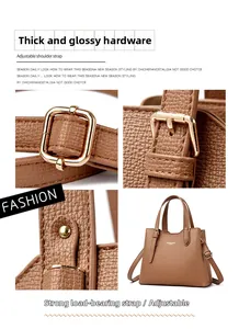 Detail of brown litchi pattern leather bag with adjustable gold-tone metal buckle