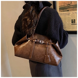 Brown vintage shoulder bag in oily wax PU leather with buckle detail and hangtag