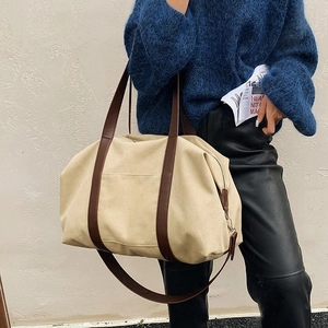 Versatile beige canvas tote bag with dark brown leather straps for commuting